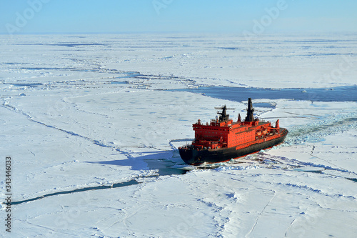 Red icebreaker in the middle of Arctic ocean