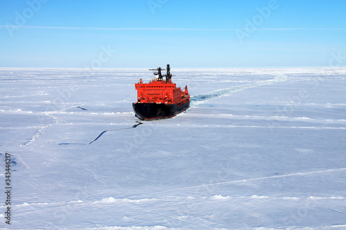 Red icebreaker in the middle of Arctic ocean