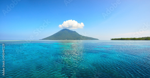 Beautiful panoramic view of volcanic island of Manado Tua on summer day. North Sulawesi, Indonesia photo