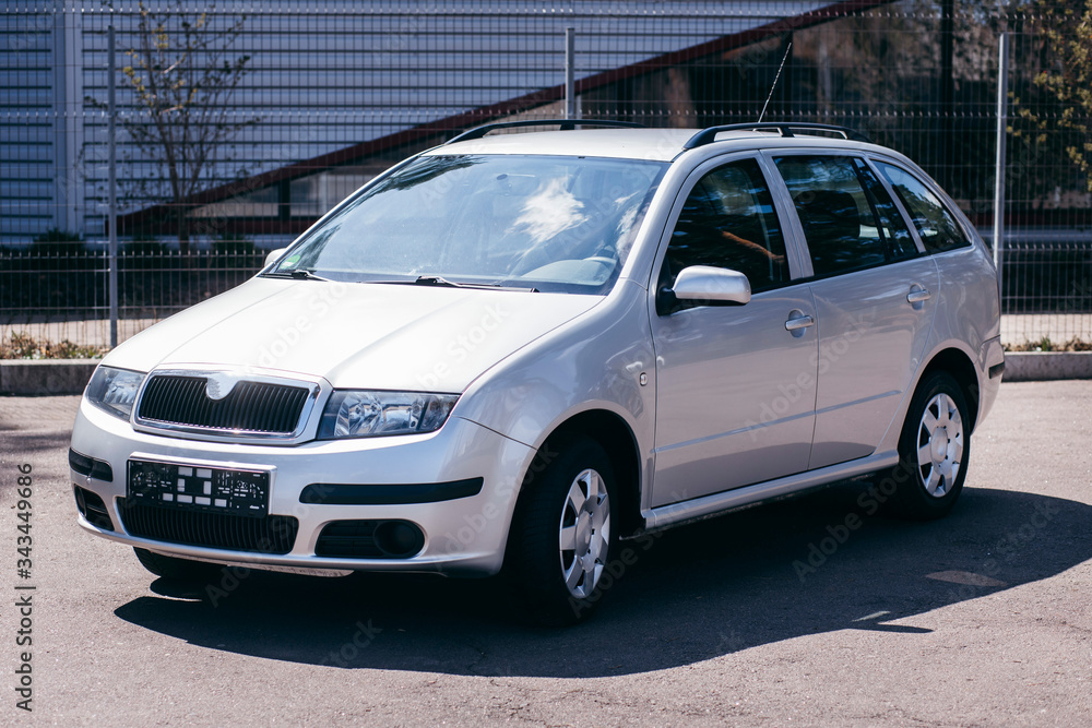 Asphalt road with cars passing through the forest. Landscape in summer day