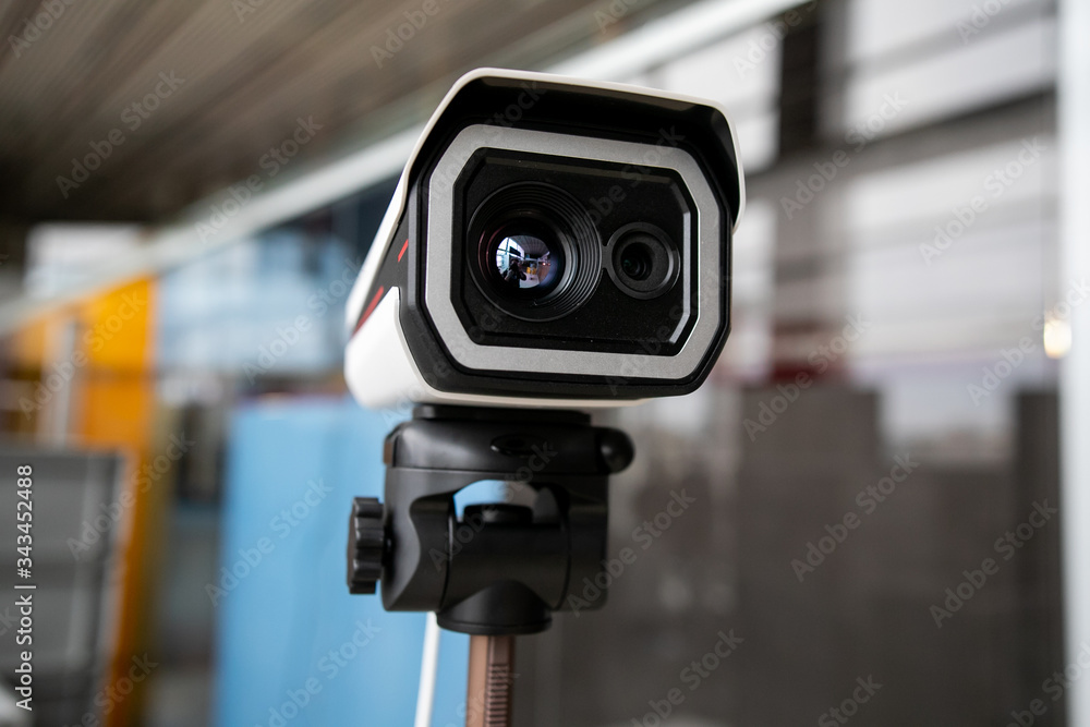 Thermal imaging camera at the airport. It is used to detect airport passengers temperature and determine high risk passenger of transmitting a disease Thermal imaging camera at the airport. It is used to detect airport passengers temperature and determine high risk passenger of transmitting a disease