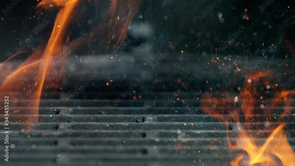 Cast iron grate with Fire flames and sparkles, shooting on high speed camera at 1000fps Cast iron grate with Fire flames and sparkles, shooting on high speed camera at 1000fps