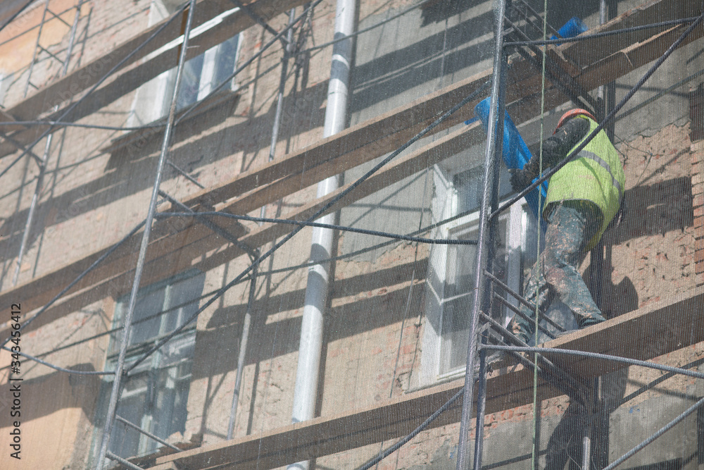 Worker on Scaffolding on building in the city