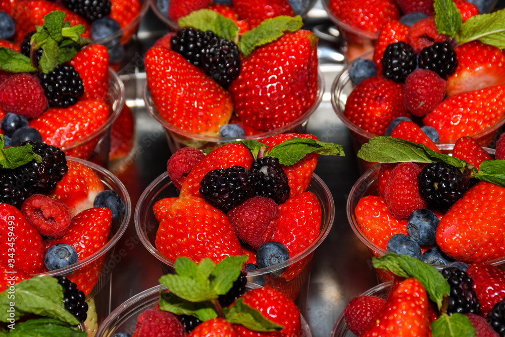 Freshly picked strawberries in plastic glass for sale in Italy Freshly picked strawberries in plastic glass for sale in Italy