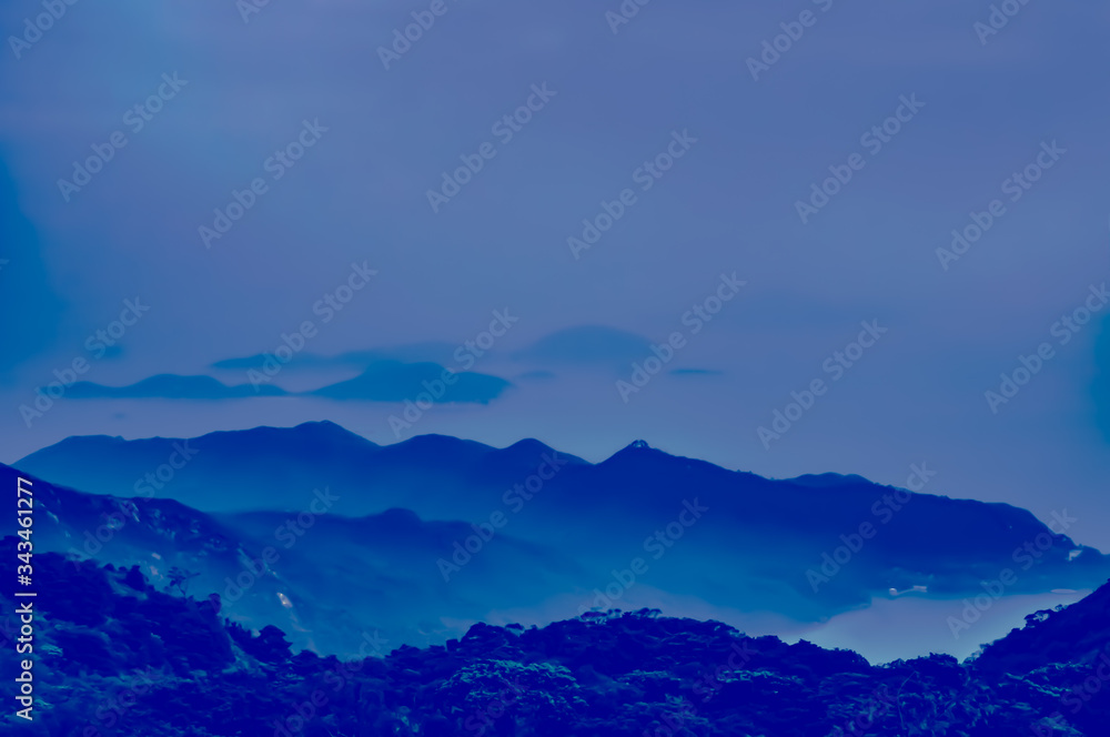 Dreamy landscape lost in thick fog. mystic evening glowing by moonlight, foggy valley. Blurred Background. 