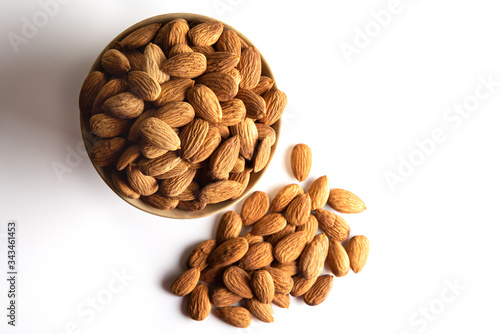 Almond Dry fruits in a brown bowl against white background
