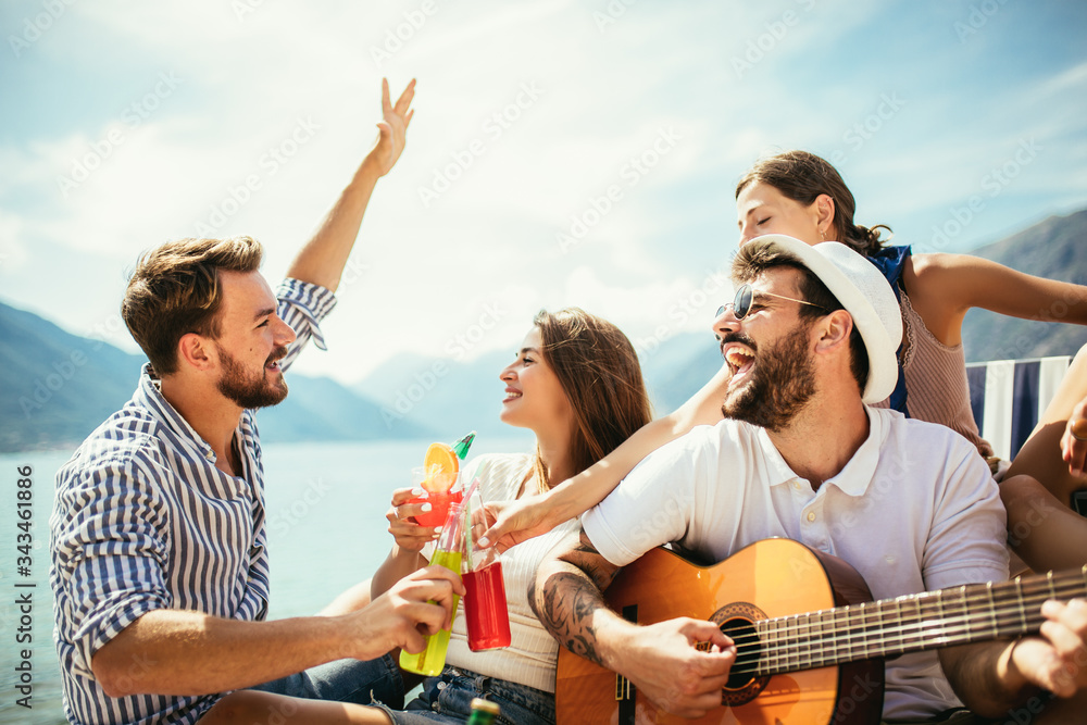 Happy young people having fun at beach party. Happy young people having fun at beach party.