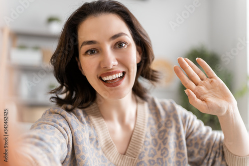 Wallpaper Mural woman is using phone for remote conversation Torontodigital.ca
