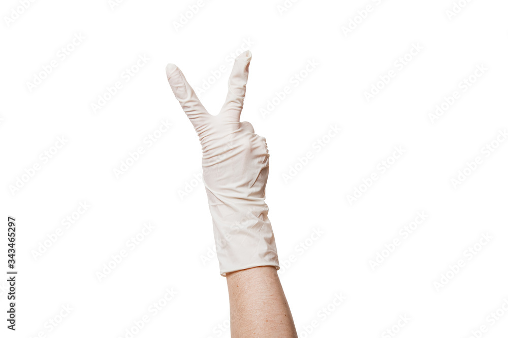 hand in a white sterile medical glove shows two fingers a gesture of peace and victory, close-up mock-up isolated on a white background with copy space. hand in a white sterile medical glove shows two fingers a gesture of peace and victory, close-up mock-up isolated on a white background with copy space.