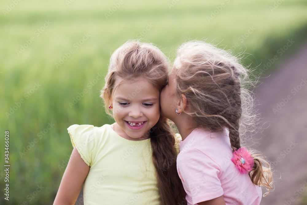 Two little girls in a field portrait Two little girls in a field portrait