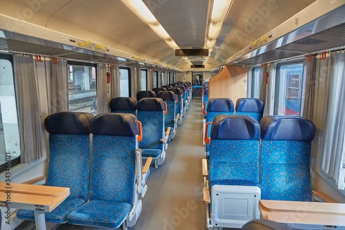 Interior of a passenger train with empty seats, no people during quarantine lockdowns