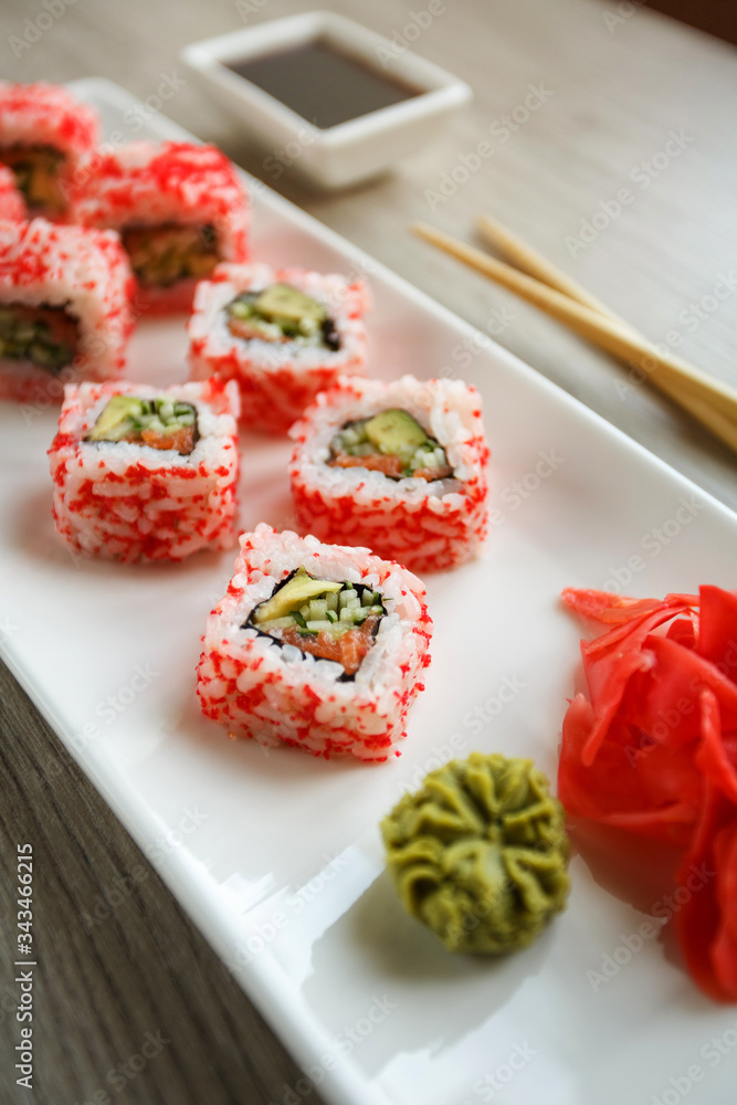 Roll with salmon, cucumber, avocado and caviar for sushi lovers. Japanese and Chinese cuisine. Roll with salmon, cucumber, avocado and caviar for sushi lovers. Japanese and Chinese cuisine.