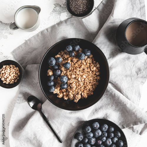 Breakfast with muesli, blueberry, coffee on white background. Healthy food concept. Flat lay, top view