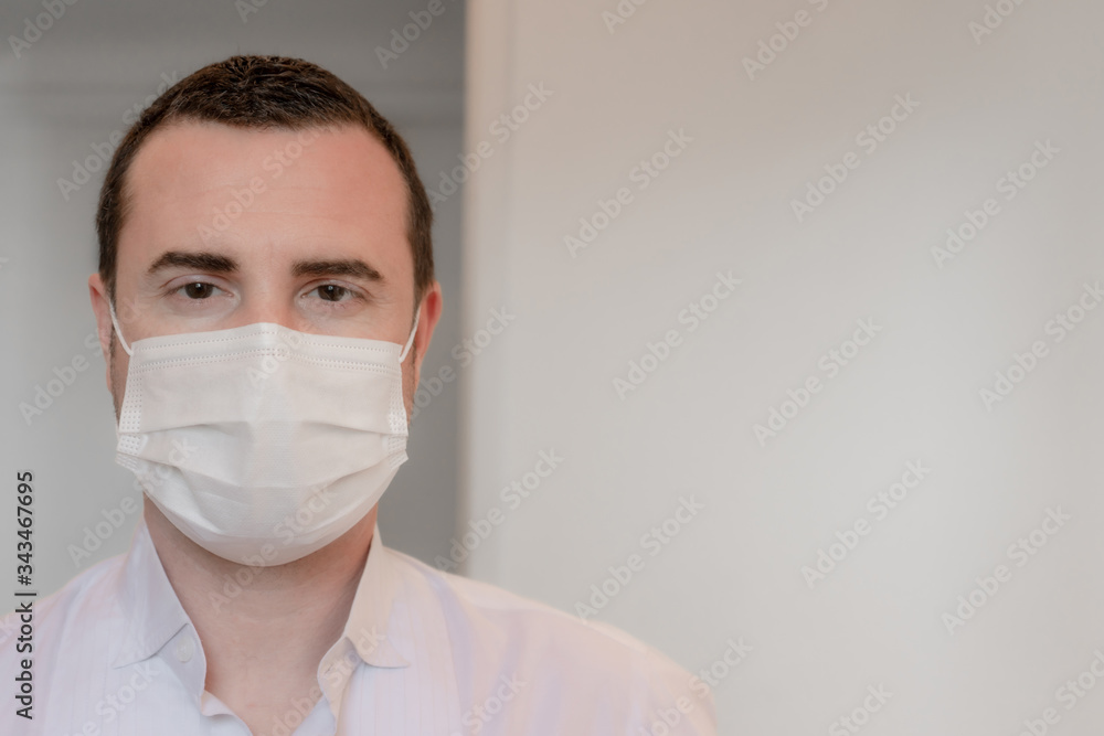 Closeup of man in mask, concept of viral infection. Theme of corona-virus epidemic Personal care during pandemic infectious disease outbreak