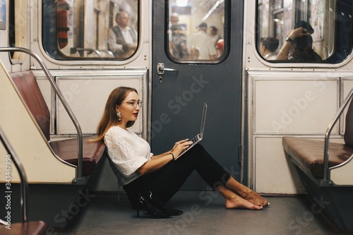 girl with laptop in subway