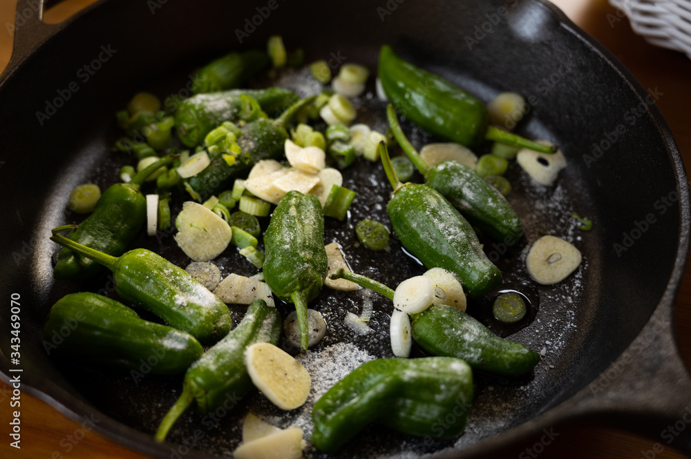 snack paprika with garlic and onions in a castiron pan as a delicious