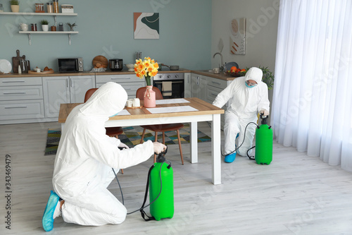 Workers in biohazard suits ...