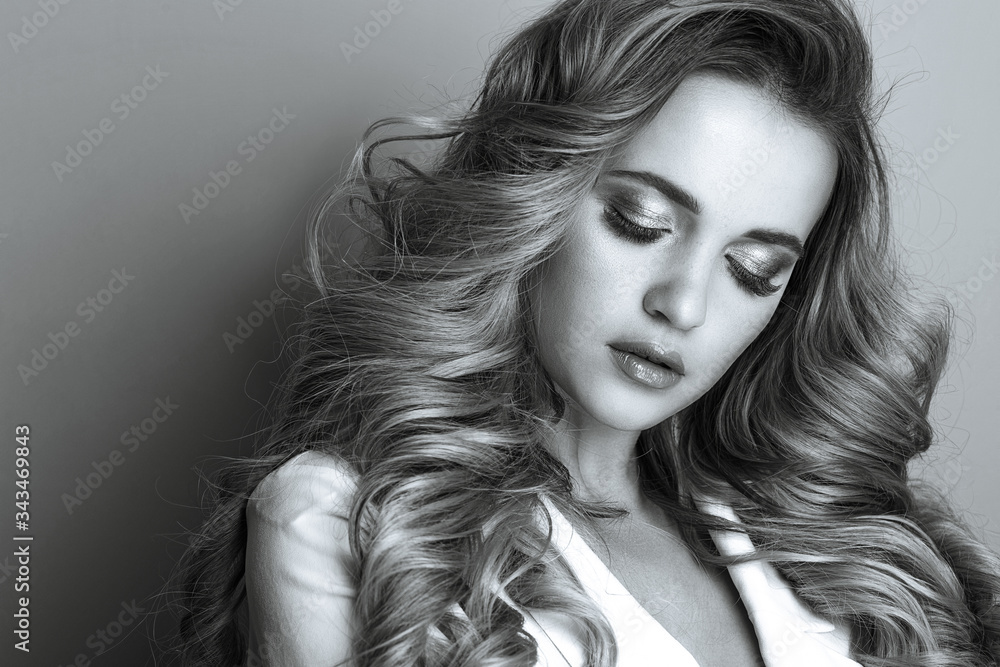 Naklejka premium Beauty portrait of adorable lady with long wavy hair