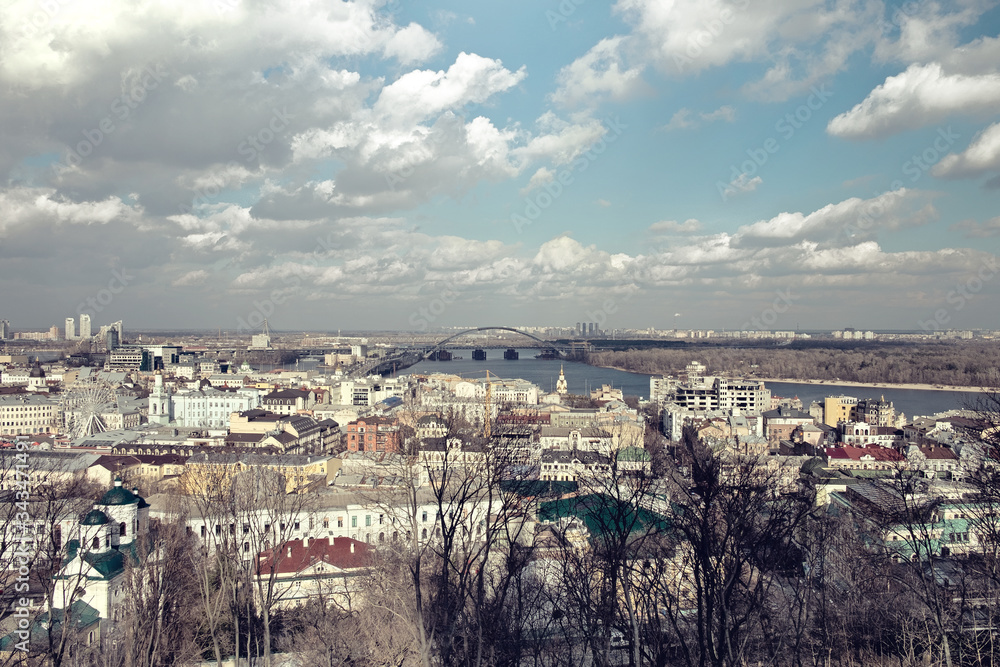 City landscape, clouds over the river in the sunlight. Ukraine, Kiev, the Dnieper River.
