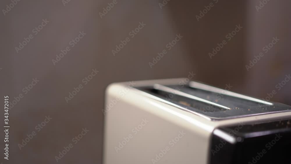 Lower the lever of bread toaster and wait until the bread pops up. Lower the lever of bread toaster and wait until the bread pops up.