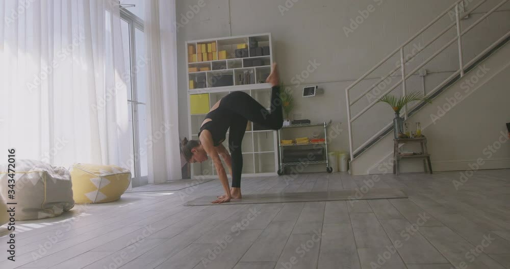 Woman Practicing Yoga in Bright Studio Woman Practicing Yoga in Bright Studio