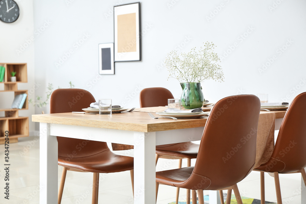 Served table in modern dining room Served table in modern dining room