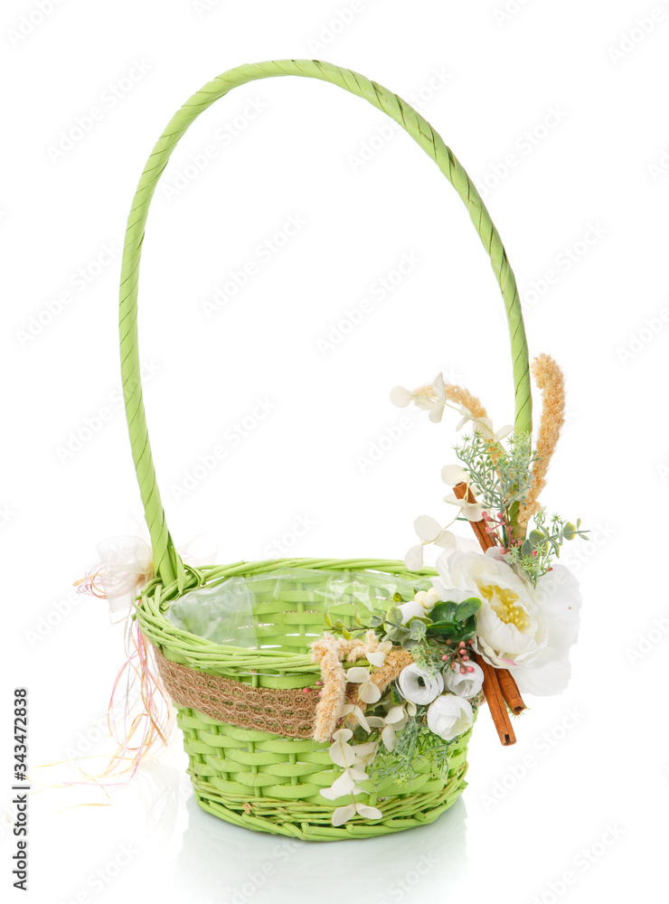 Wicker basket decorated with flowers on white background