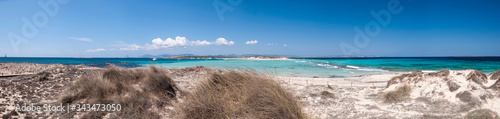 Big panoramic photo Formentera Espalmador beach. In the background sailboats anchored in the bay and the coast of Ibiza; Balearic islands; Spain; Europe