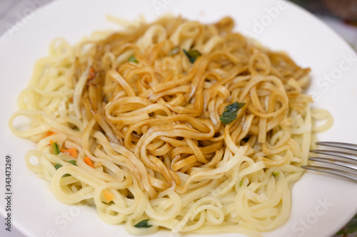 Instant noodles in white plate. Close-up.