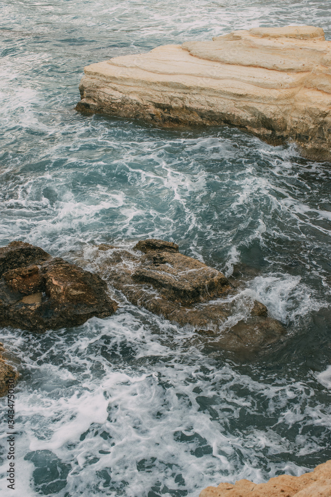 white foam near rocks in blue water of mediterranean sea white foam near rocks in blue water of mediterranean sea