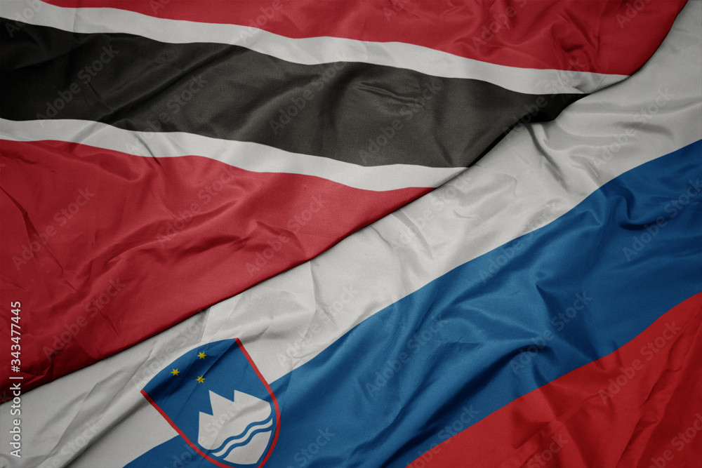 waving colorful flag of slovenia and national flag of trinidad and tobago. waving colorful flag of slovenia and national flag of trinidad and tobago.