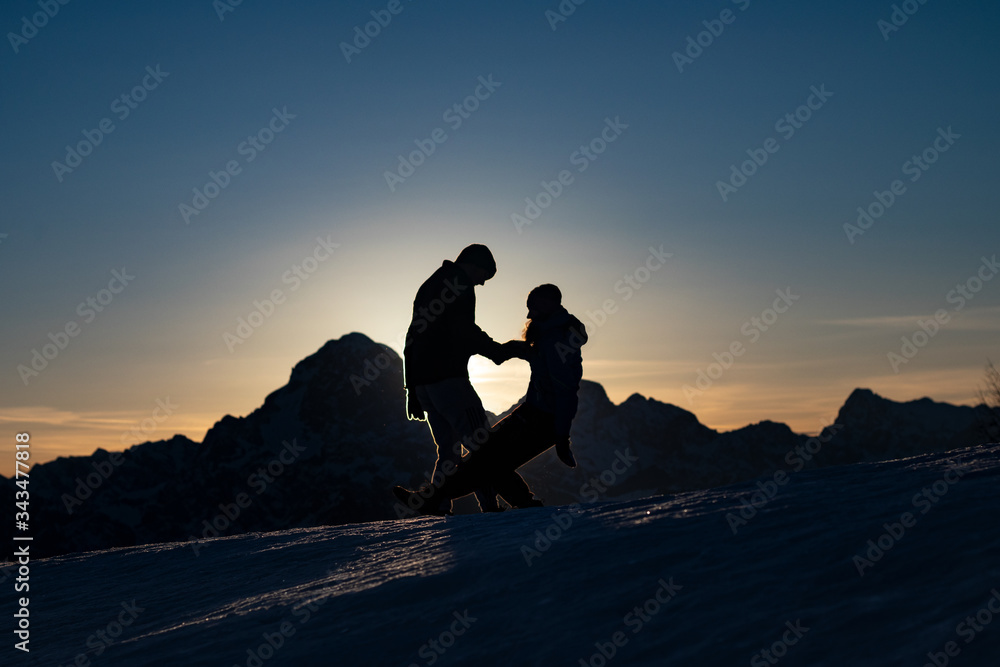 silhouette of couple on the mountain top