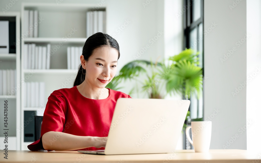 Work at home, Video conference, Online meeting video call, Portrait of beautiful young asian woman looking at computer screen watching webinar and working on laptop in workplace Work at home, Video conference, Online meeting video call, Portrait of beautiful young asian woman looking at computer screen watching webinar and working on laptop in workplace