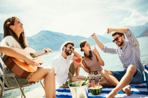 Happy young people having fun at beach party.