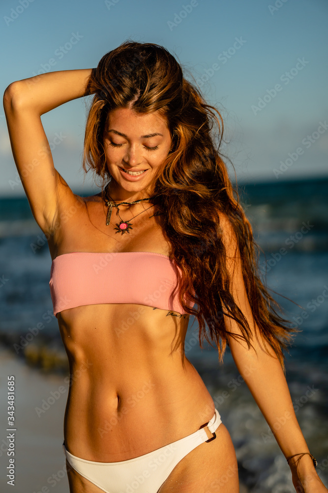 Pretty young redhead female model having fun by the sea. Pretty young redhead female model having fun by the sea.