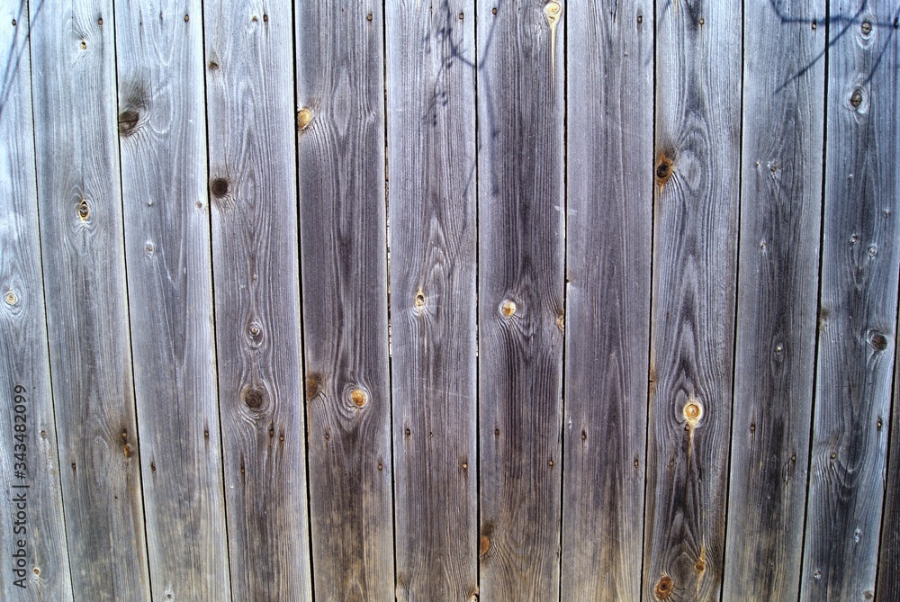 A fragment of a fence made of wooden boards with a beautiful wood texture A fragment of a fence made of wooden boards with a beautiful wood texture