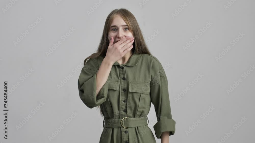 Amazing young shocked excited girl posing isolated over grey wall background. Amazing young shocked excited girl posing isolated over grey wall background.