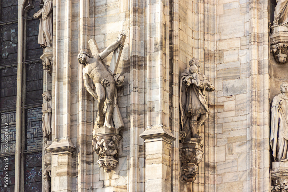 Statues decorating the side wall of the Cathedral of Milan - Duomo di Milano in Milan city, Italy