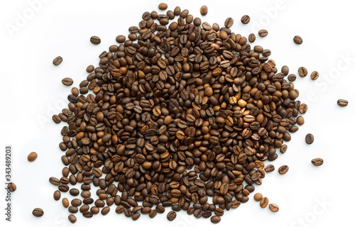 Selected calibrated Arabica coffee beans scattered on a white surface, table, blended, isolated, top view
