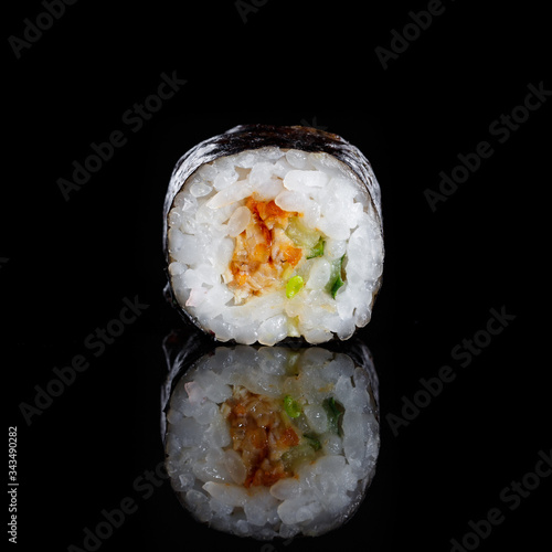 Maki sushi with rice, salmon, cucumber, and nori closeup.