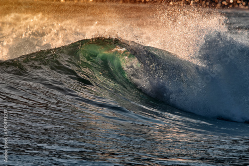 Fototapeta Naklejka Na Ścianę i Meble -  Blue Ocean Wave Getting Barreled at Sunset. Perfect wave for surfing