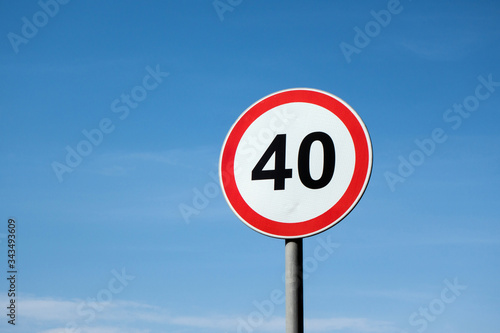 International traffic sign 'Speed limit' (to 40 km per hour). Blue sky is on  background photo