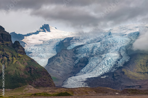 View of Virkisjokull and Falljokull glaciers as seen from route 1, Iceland. These are two of around 30 other outlet glaciers flowing from the ice cap of Vatnajokull, the largest glacier in Iceland