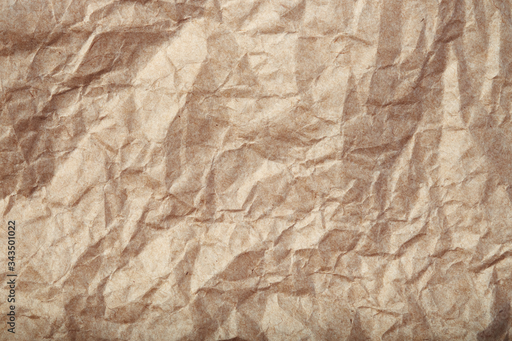 Crumpled beige paper texture closeup Crumpled beige paper texture closeup