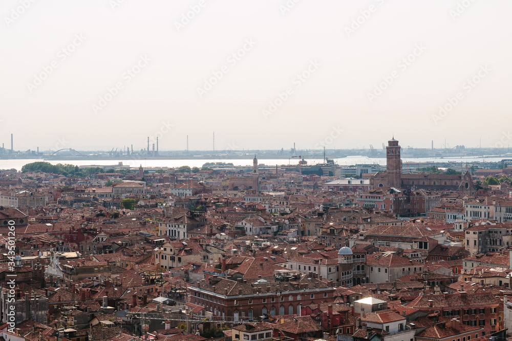 Venice in summer time. Italian view. Roof, sea, boats in sunny day. Old city, ancient buildings. Popular tourist destination of Italy. Europe. Top view from Saint mark's tower. Torre dell'orologio.