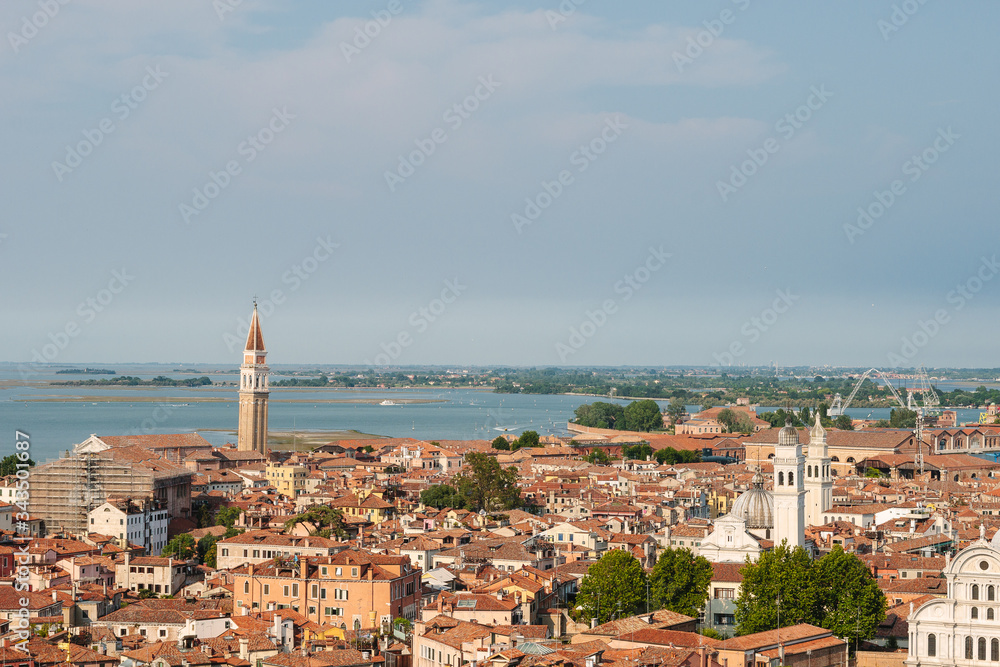 Venice in summer time. Italian view. Roof, sea, boats in sunny day. Old city, ancient buildings. Popular tourist destination of Italy. Europe. Top view from Saint mark's tower. Torre dell'orologio.