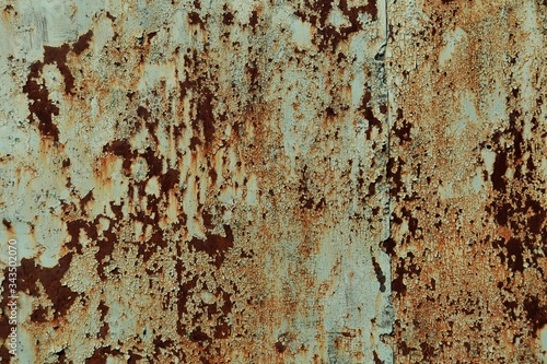 Iron rusty surface with remains of beige paint.