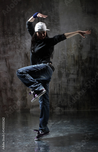 Young beautiful dancer is posing in studio