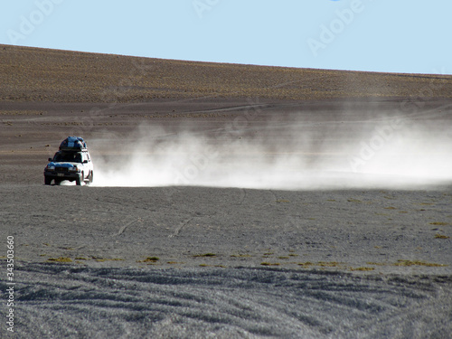 off road vehicle in dust cloud