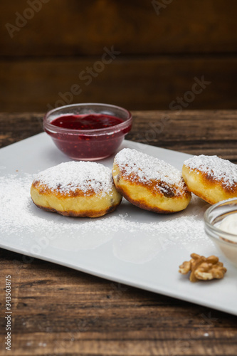 Cheesecakes on plate on wooden background